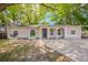 Charming single-story home with a spacious front yard and inviting curb appeal enhanced by mature trees at 4748 Amoy Ct, Orlando, FL 32811