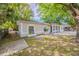Charming single-story home with a spacious front yard and inviting curb appeal enhanced by mature trees at 4748 Amoy Ct, Orlando, FL 32811