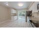 Bright kitchen featuring stainless steel appliances, granite countertops, and sliding glass doors to the backyard at 4748 Amoy Ct, Orlando, FL 32811