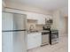 Galley kitchen featuring stainless steel appliances, granite countertops, and white cabinetry at 4748 Amoy Ct, Orlando, FL 32811