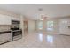 Modern kitchen featuring stainless steel appliances, white cabinets, and ample counter space for meal preparation at 4748 Amoy Ct, Orlando, FL 32811