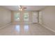Bright living room featuring tile floors, ceiling fan, and a front door entry at 4748 Amoy Ct, Orlando, FL 32811