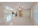Open-concept living area with tile flooring, connecting the kitchen and living spaces for easy entertaining at 4748 Amoy Ct, Orlando, FL 32811