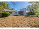 The backyard view showcasing the home's exterior and lawn at 4805 Okeefe St, Orlando, FL 32808