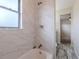 This remodeled bathroom features a shower/tub combo with modern fixtures at 4805 Okeefe St, Orlando, FL 32808