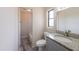 Bathroom showing vanity with granite countertop, window, and updated shower/tub at 4805 Okeefe St, Orlando, FL 32808