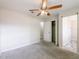 Bedroom showcasing ceiling fan, carpet, and easy access to a closet and bathroom at 4805 Okeefe St, Orlando, FL 32808