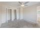 This bedroom offers carpet floors, a ceiling fan, and two closets with white doors at 4805 Okeefe St, Orlando, FL 32808