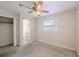 A neutral bedroom features a ceiling fan, window, and convenient en-suite bathroom at 4805 Okeefe St, Orlando, FL 32808