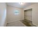 The bedroom features a small window, carpet floors and a closet with shelving at 4805 Okeefe St, Orlando, FL 32808