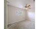 This is a simply decorated bedroom with neutral walls, carpet and a ceiling fan at 4805 Okeefe St, Orlando, FL 32808