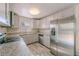 Modern kitchen features stainless steel appliances, granite countertops, and wood-look tile flooring at 4805 Okeefe St, Orlando, FL 32808