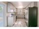Modern kitchen with stainless steel appliances, white cabinets, and stylish flooring at 4805 Okeefe St, Orlando, FL 32808