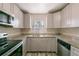 Well-lit kitchen features stainless steel appliances, granite countertops, and gray cabinets at 4805 Okeefe St, Orlando, FL 32808