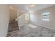 Open living area with staircase, wood-look flooring and neutral wall paint at 4805 Okeefe St, Orlando, FL 32808