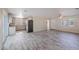 Open-concept space with sleek flooring and a seamless transition to the modern kitchen at 4805 Okeefe St, Orlando, FL 32808