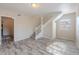 Open living space with staircase, neutral paint and wood-look flooring at 4805 Okeefe St, Orlando, FL 32808