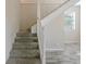 Carpeted staircase leading to the upper level, featuring wood-look tile flooring and neutral wall paint at 4805 Okeefe St, Orlando, FL 32808