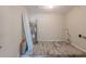 Utility area featuring a water heater, tile floors and additional storage at 4805 Okeefe St, Orlando, FL 32808