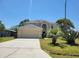 Two-story home with attached garage, nice landscaping, and well-kept lawn at 502 Eagle Ct, Kissimmee, FL 34759