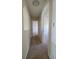 Hallway view with neutral paint, showing doorways leading to other rooms in the home at 502 Eagle Ct, Kissimmee, FL 34759