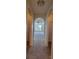 Neutral-toned hallway showcasing arched doorways leading into other rooms of the home at 502 Eagle Ct, Kissimmee, FL 34759