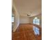 Empty living room with tile flooring, ceiling fan, and natural light at 502 Eagle Ct, Kissimmee, FL 34759