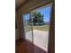 View through sliding glass doors to concrete patio and grassy yard at 502 Eagle Ct, Kissimmee, FL 34759