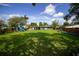 Expansive backyard with mature trees, playground, hammock, and ample space for outdoor activities at 5384 Barton Dr, Orlando, FL 32807