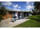 Private backyard patio with outdoor seating and tropical landscaping at 5384 Barton Dr, Orlando, FL 32807