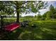 Backyard featuring lake views, a porch swing, comfortable seating, and a cozy fire pit area at 5384 Barton Dr, Orlando, FL 32807