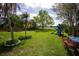 Expansive backyard with play equipment, a wooden fence, and a glimpse of the lake at 5384 Barton Dr, Orlando, FL 32807
