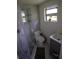 Modern bathroom featuring a corner shower with glass doors and gray tiling at 5384 Barton Dr, Orlando, FL 32807