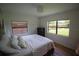 Serene bedroom with garden view, bright natural light, and minimalist decor for peaceful sleep at 5384 Barton Dr, Orlando, FL 32807