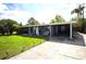 Charming single-story home with well-maintained lawn and inviting front porch area with an American flag at 5384 Barton Dr, Orlando, FL 32807