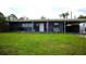 Charming home with a well-manicured lawn, covered front porch, and an inviting American flag at 5384 Barton Dr, Orlando, FL 32807