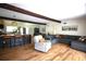 Open concept living room and kitchen with hardwood floors and exposed beams at 5384 Barton Dr, Orlando, FL 32807