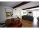 Cozy living room features neutral paint, wood beam and floors at 5384 Barton Dr, Orlando, FL 32807