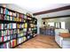 Stylish living space with floor-to-ceiling bookshelves open to kitchen at 5384 Barton Dr, Orlando, FL 32807