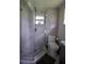 Modern bathroom shower with a gray chevron pattern tile, rainfall shower head, and glass enclosure at 5384 Barton Dr, Orlando, FL 32807