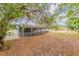 Charming home featuring a covered back porch and spacious backyard at 5500 Riviera Dr, Orlando, FL 32808