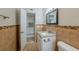 Tiled bathroom featuring a granite vanity, toilet, mosaic tile accent, and modern fixtures at 5500 Riviera Dr, Orlando, FL 32808