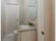 Bathroom features a granite vanity with sink and oval mirror and toilet at 5500 Riviera Dr, Orlando, FL 32808