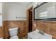 Bathroom with a tiled accent wall, with a white sink and mirror at 5500 Riviera Dr, Orlando, FL 32808