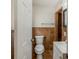 Toilet next to the sink inside of a bathroom with tiled walls at 5500 Riviera Dr, Orlando, FL 32808