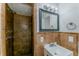 Bathroom features a tiled shower stall with updated showerhead, vanity, and mirror at 5500 Riviera Dr, Orlando, FL 32808