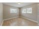 Bright bedroom has neutral walls, a ceiling light, and two windows for natural light at 5500 Riviera Dr, Orlando, FL 32808