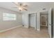 Bright bedroom featuring a ceiling fan, closet, and light hardwood floors at 5500 Riviera Dr, Orlando, FL 32808