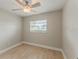 Bedroom has neutral paint, a ceiling fan, and wood-look flooring at 5500 Riviera Dr, Orlando, FL 32808