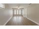 Neutral bedroom with wood-look flooring, ceiling fan, and three windows providing ample natural light at 5500 Riviera Dr, Orlando, FL 32808